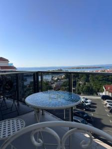 a table on a balcony with a view of the ocean at Hotel Filland in Sozopol
