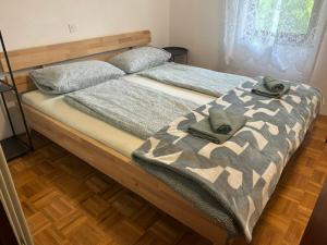 a bed with two pairs of shoes on it at Roja House in Soča