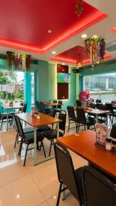 a dining room with tables and chairs in a restaurant at Hotel Apsara Temerloh Gateway in Temerloh