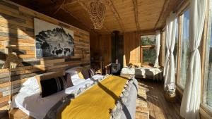 a bedroom with two beds in a wooden room at Alto Castillo Lodge in Villa Cerro Castillo
