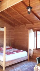 a bedroom with a bed in a wooden room at Sakin Vadi Winehouse in Orhaniye