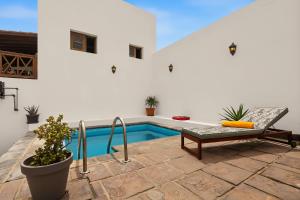 a patio with a pool and a bench next to at Rincón de Daute in Los Silos