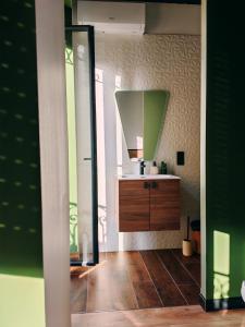 a bathroom with a sink and a mirror at La Bulle Carrée - Centre Historique médiéval - in Lapalme