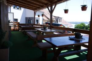 a row of tables and benches on a patio at Penzion u Bednářů in Pavlov
