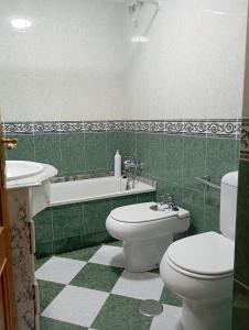 a bathroom with a toilet and a sink and a tub at Casa Chus in Foz +22 photos