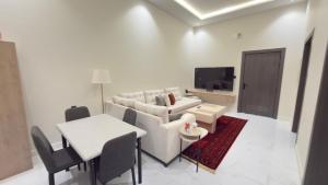 a living room with a couch and a table at شقق ميلا الباحة الفاخرة in Al Baha