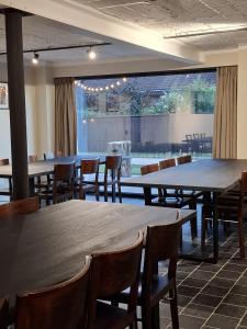 a restaurant with tables and chairs and a large window at De Flamberthoeve in Ieper +16 photos