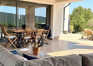 a living room with a couch and a table and chairs at Pannon Grace Balaton in Dörgicse +30 photos