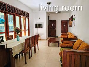 a living room with a table and a living room at Ocean Breeze Apartment Colombo in Colombo