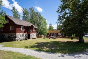 a house with a picnic table in front of it at STF Korrö Gårdshotell in Linneryd