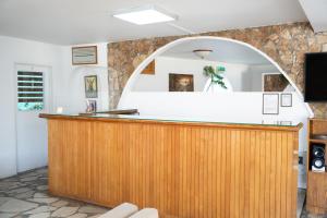 a bar in a room with a mirror at Le Village Hotel in Limassol