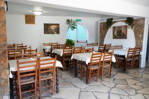 a restaurant with tables and chairs in a room at Le Village Hotel in Limassol