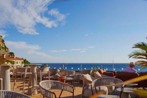a view of the ocean from a resort patio at Hôtel Liautaud Cassis by Germain Collection in Cassis