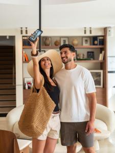 a man and a woman holding up a cell phone at Hôtel Liautaud Cassis by Germain Collection in Cassis +80 photos