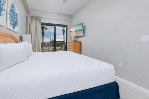 a bedroom with a large white bed and a window at Phoenix VI 6004 in Orange Beach +56 photos