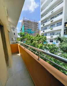 a balcony with a view of a building at Ocean Breeze Apartment Colombo in Colombo