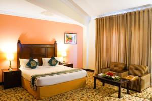 a hotel room with a bed and a chair at Hotel Hillview Islamabad in Islamabad +44 photos