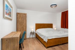 a bedroom with a bed and a wooden table at Villa Bagulina in Drniš +28 photos