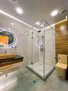 a bathroom with a glass shower and a sink at ASR Plaza in Jizzax +73 photos