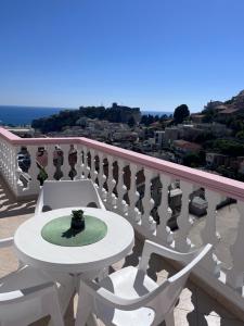 a white table and chairs on a balcony at Castello Apartments in Ulcinj
