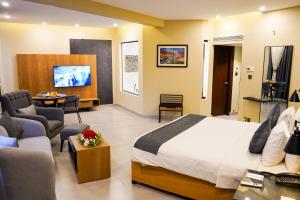 a hotel room with a bed and a living room at Hotel Hillview Islamabad in Islamabad