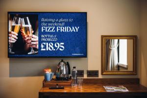 a mirror and a table with two glasses of champagne at George & Dragon Hotel in Kirkbymoorside