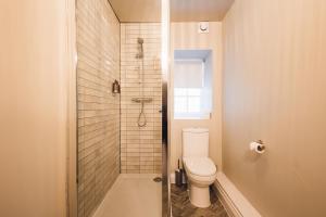 a bathroom with a toilet and a shower at George & Dragon Hotel in Kirkbymoorside