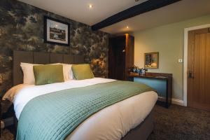 a bedroom with a large bed in a room at George & Dragon Hotel in Kirkbymoorside