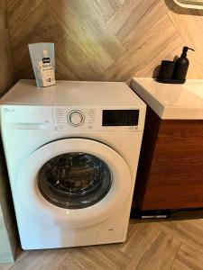 a white washer and dryer in a kitchen at Ziemupes namiņš in Ziemupe