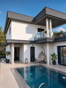 a house with a swimming pool in front of it at Villa VELUNA Liznjan Residence in Ližnjan