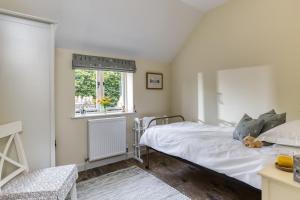 a bedroom with a bed and a window at Downclose Piggeries in North Perrott