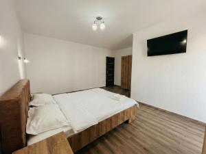 a bedroom with a bed and a flat screen tv at Vila Diana in Venus