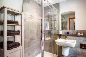 a bathroom with a shower and a sink at Oakbank Farm in Lamlash +67 photos