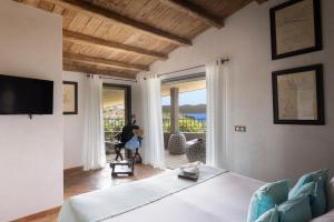 a living room with a bed and a large window at U Capu Biancu in Bonifacio