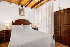 a bedroom with a bed with white sheets and a window at Romantic Room - Charming Place in Provesende +26 photos