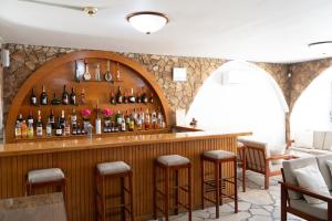 a bar in a restaurant with bottles on the wall at Le Village Hotel in Limassol +11 photos