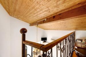 a room with a wooden ceiling and a staircase at Romantic Room - Charming Place in Provesende