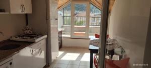 a kitchen with a sink and a stove top oven at WoodenGate in Fethiye