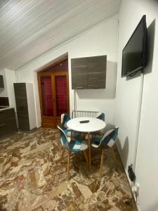 a room with a table and chairs and a television at Sole di Lercara in Lercara Friddi