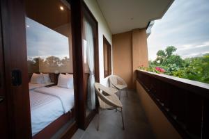 a hotel room with a bed and a window at Padang Padang Inn in Uluwatu +92 photos