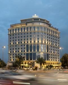 a large building with a street in front of it at Grand Bloom Hotel in Baghdād