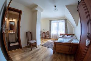 a bedroom with a bed and a large mirror at Gościniec Polana Błociska-Na Błociskach in Małe Ciche