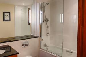 a bathroom with a shower and a sink at Links Apartment in Brora +67 photos