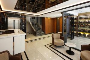 a lobby with a chair and a table and a staircase at Kalkan Hotel in Istanbul