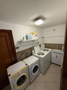 a laundry room with a washer and dryer at Royal Playa Suite and Apartament -private parking- self chek out in Catania