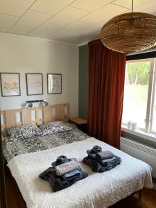 a bedroom with a bed with towels on it at NorrskensRo in Kiruna