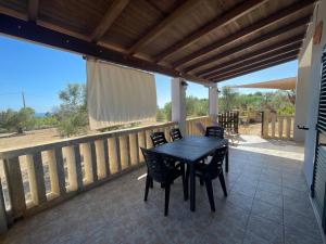 a patio with a table and chairs on a deck at Villetta PEPE nel Salento in Salve