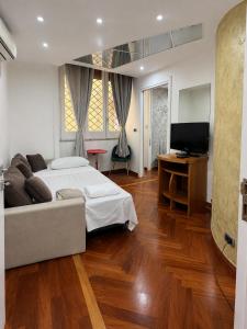 a bedroom with a bed and a television in it at Il gioiellino in Agropoli