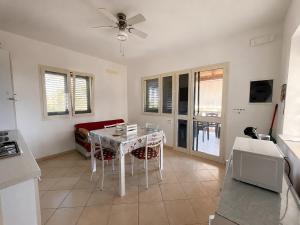 a kitchen and living room with a table and chairs at Villetta PEPE nel Salento in Salve