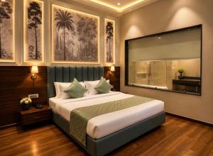 a bedroom with a large bed and a large window at Emerald Resorts and Hotel in Jāmb
